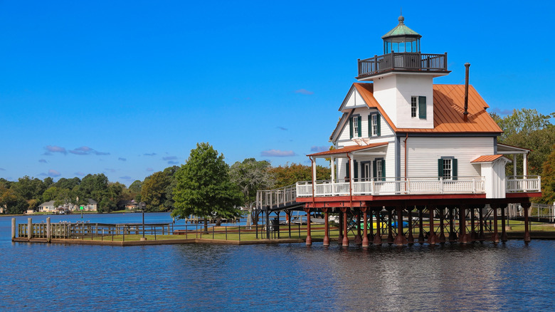 White lighthouse building on stilts over water