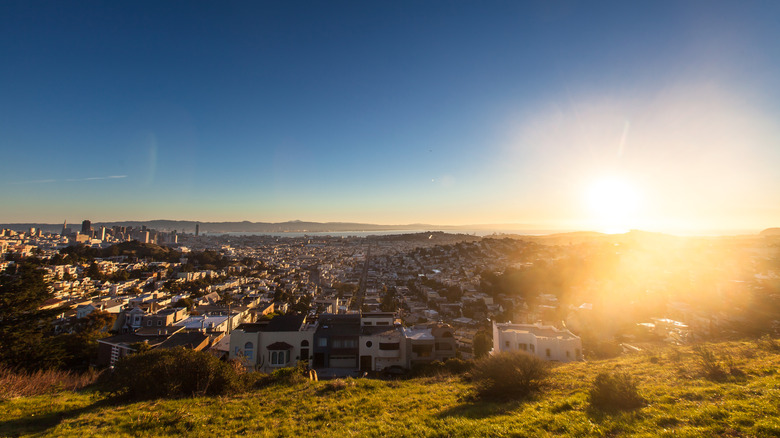 San Francisco cityscape, looking east across the Mission towards the bay as the sun rises over the water.
