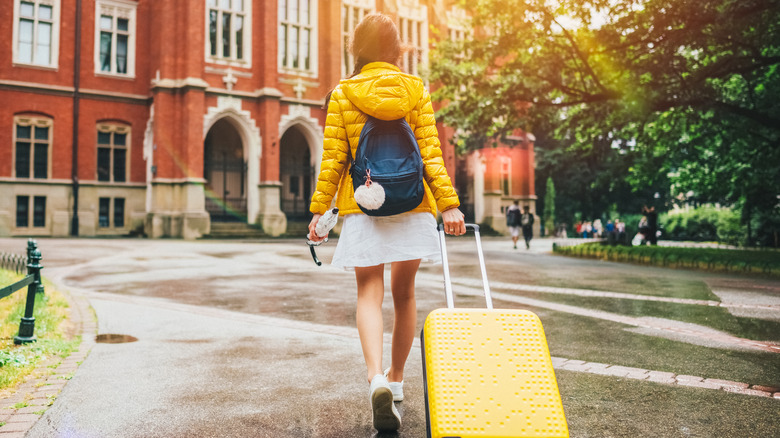 female traveler walking on campus