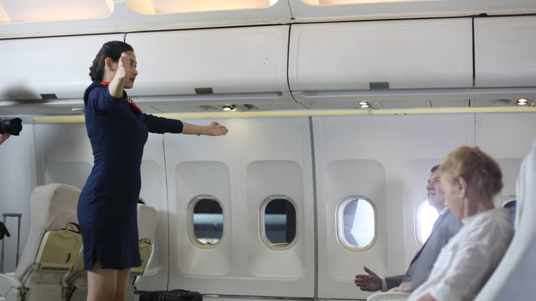 flight attendant gives safety demo