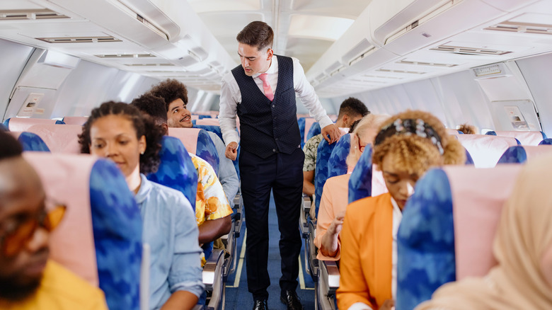 flight attendant talks to passenger