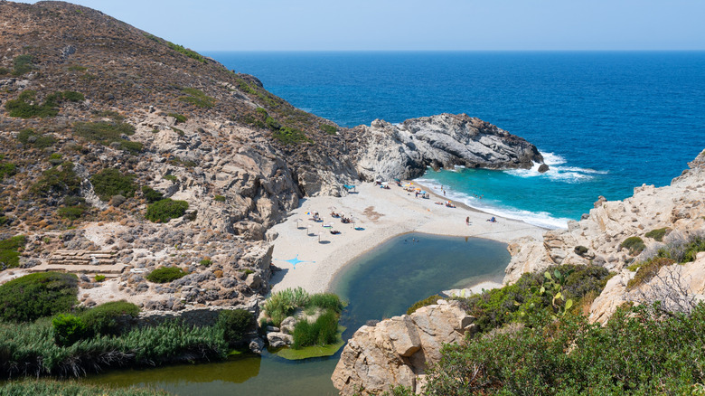 An aerial view of people chilling at Nas Beach in Greece.