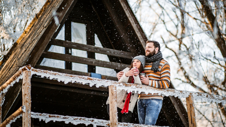 couple on cabin terrace winter