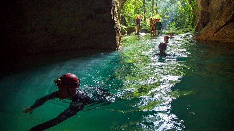Explorers entering the mouth of the ATM cave