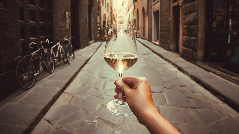 Woman holding wine glass on Florence street