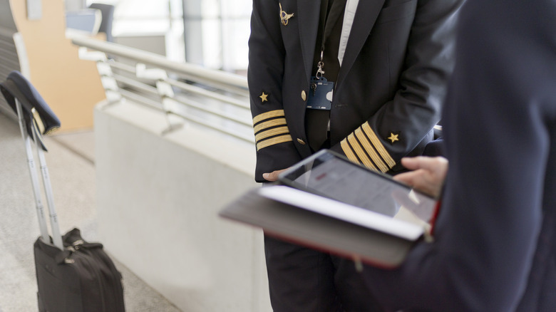 flight attendants hands on a smart device