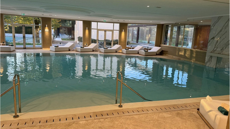 Luxurious cushioned lounge chairs line the poolside at Palazzo Fiuggi.