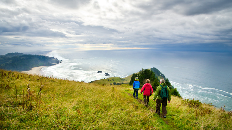 Three hikers in Cascade Head Preserve along the central coast of Oregon