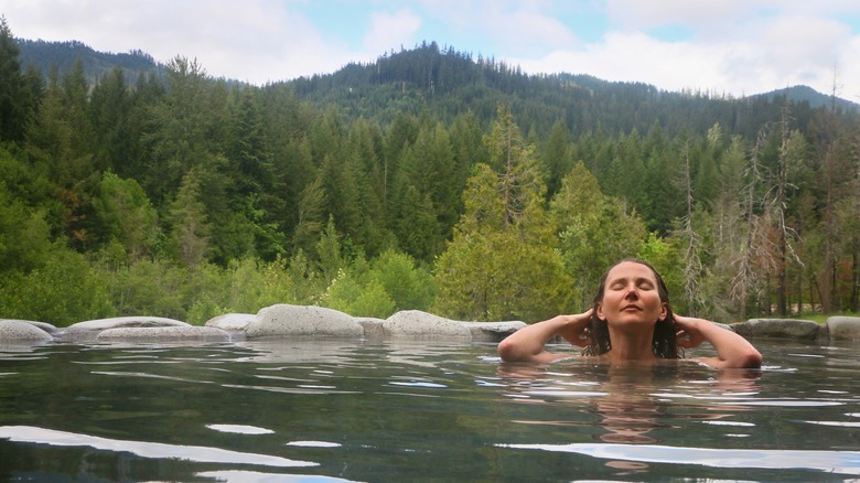 A woman soaks in a Sacred Meadow Pool at Breitenbush Hot Springs in Oregon