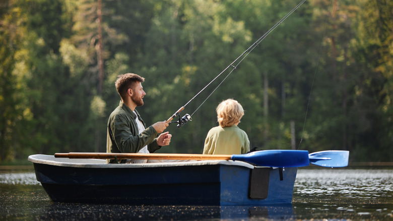 father and son fishing from a boat