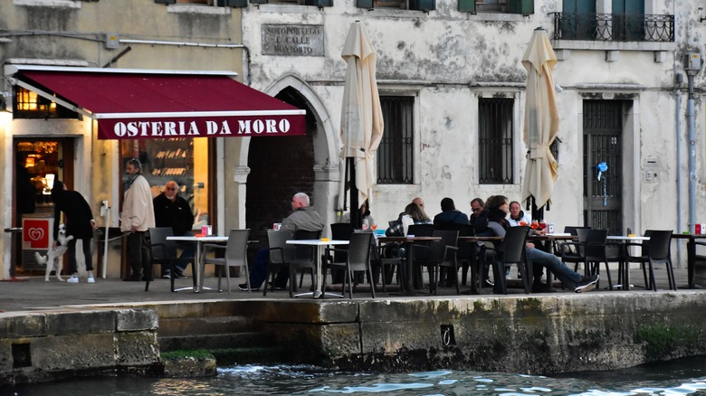 outdoor tables next to canal