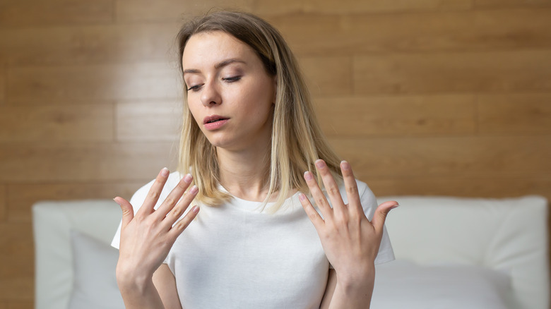 woman feeling warm in hotel