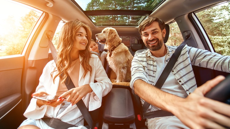 Family in car with dog