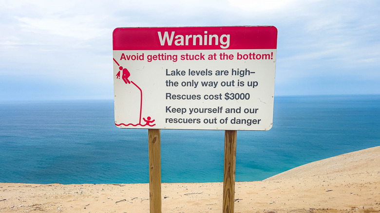 Warning sign at the Dune Climb telling hikers not to get stuck or they will pay $3000 in rescue fees