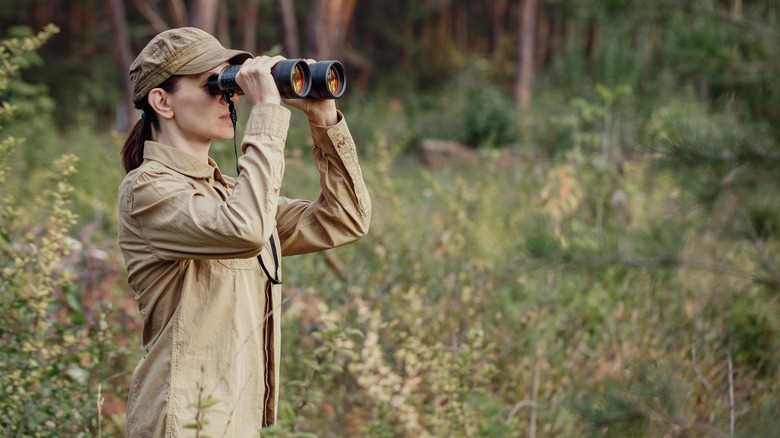 woman with binoculars in a field