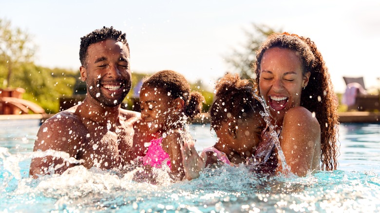 couple with kids in pool