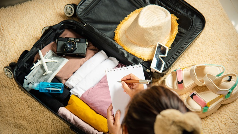 woman packing suitcase