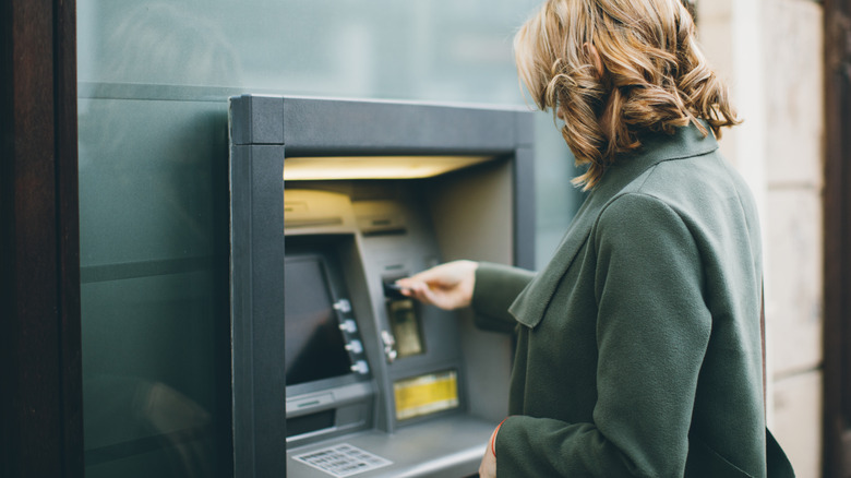 Woman using ATM machine