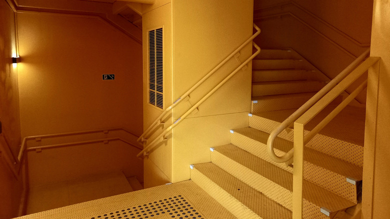 an empty staircase bathed in orange light