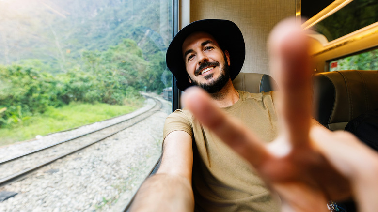 Happy man traveling on a train