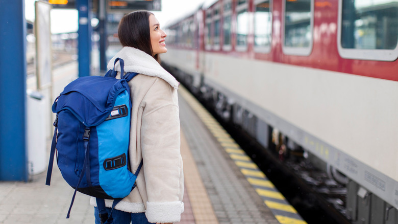 Female backpacker waiting for a train