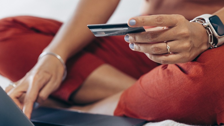 Woman with credit card and laptop