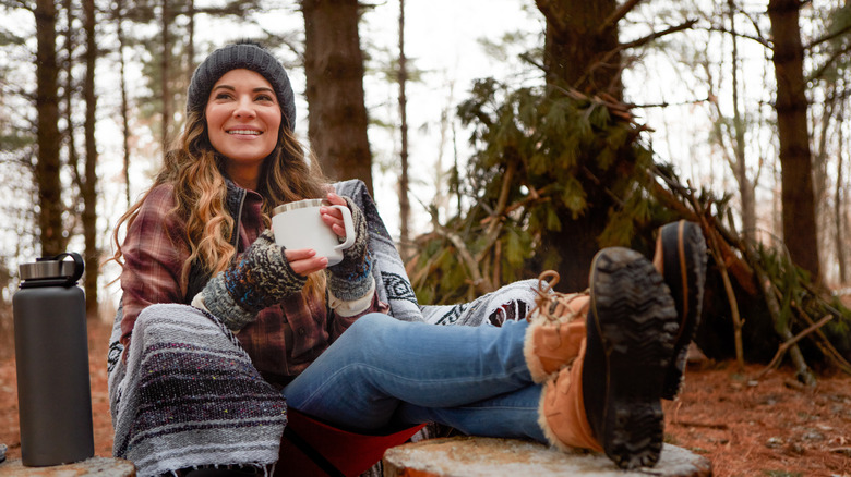 cozy woman camping in cold