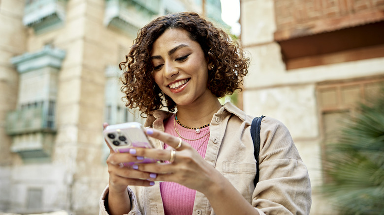 Person looking at phone outdoors