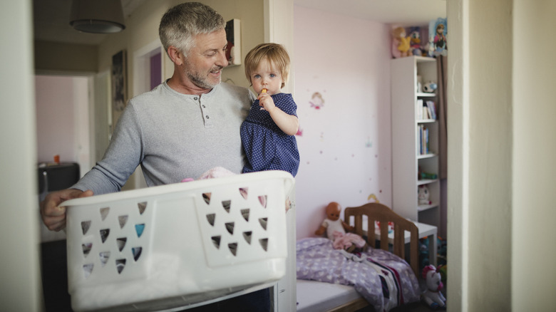 Man holding daughter and basket