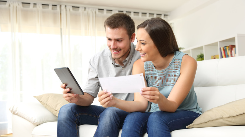 Couple with mail and tablet 