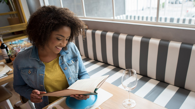 woman looking at menu