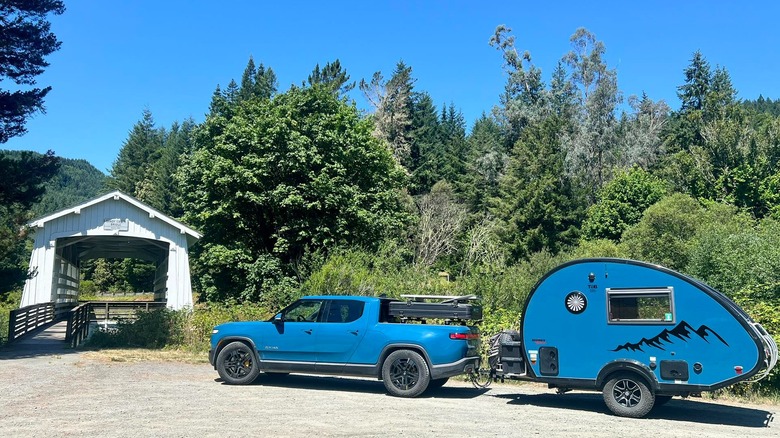 blue truck pulling a blue T@B Teardrop trailer