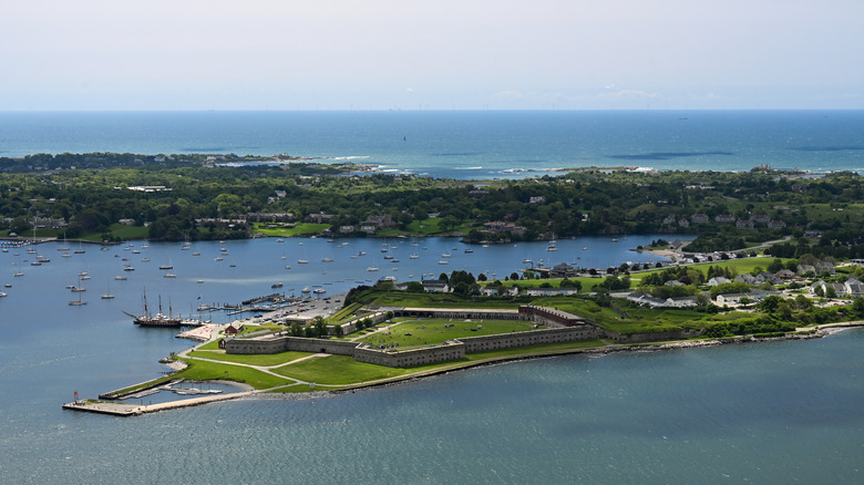Aerial View of green, grassy Fort Adams, surrounded by blue water