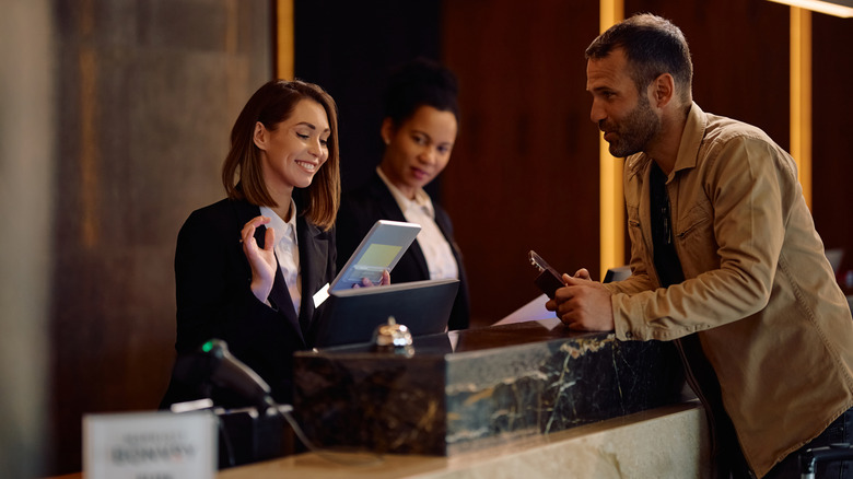 hotel worker talking to a customer