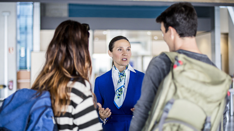 tourists talking to airport staff