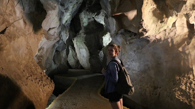 A young woman stands in a cave in Viñales, Cuba