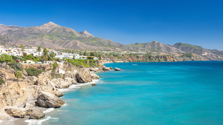 The whitewashed village of Nerja, Spain, overlooking turquoise water