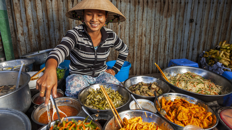 woman cooking several dishes
