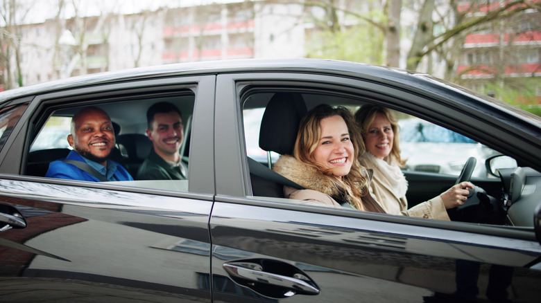 four people carpooling in a car