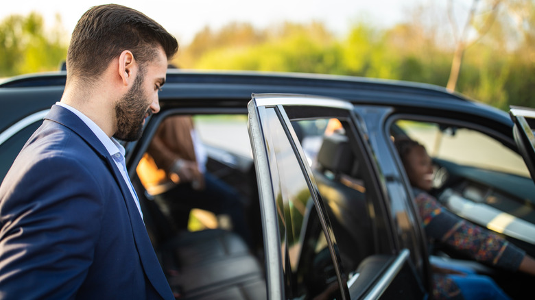 Man getting into carpool car