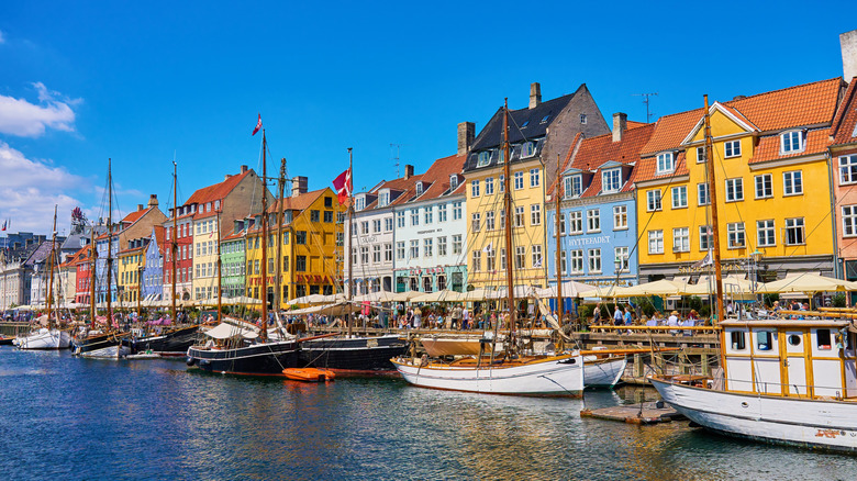 Boats alongside colorful harbor houses in Copenhagen.