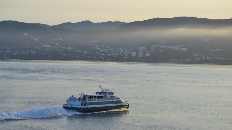 Evening ferry sailing with countryside in the background