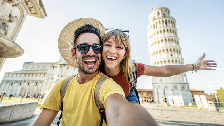 Couple taking selfie in front of Leaning Tower of Pisa