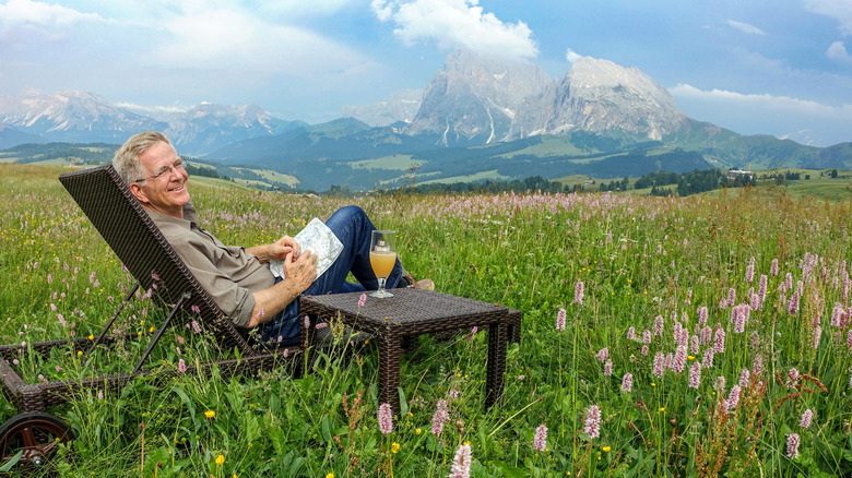 Rick Steves in mountain meadow