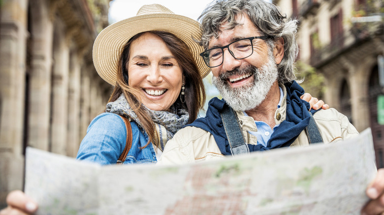 two travelers looking at map in Italy