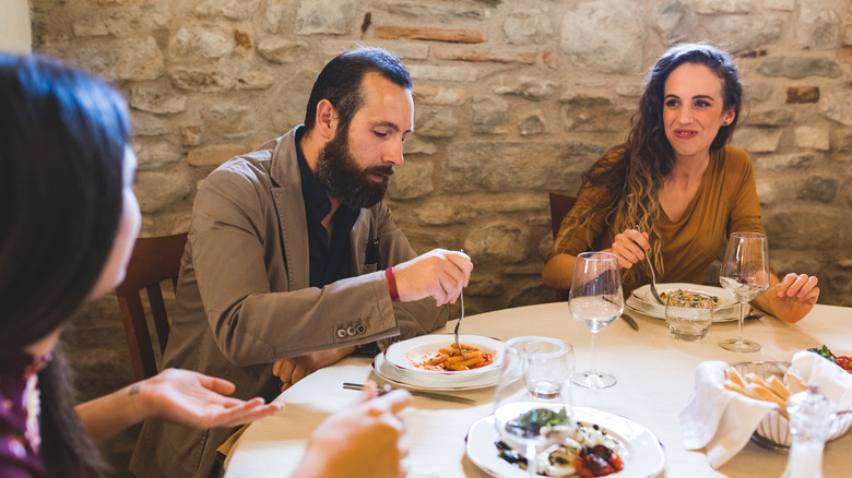Friends sharing small plates in Italy