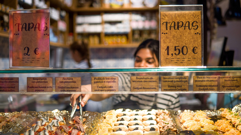 A worker serving tapas on display in Spain