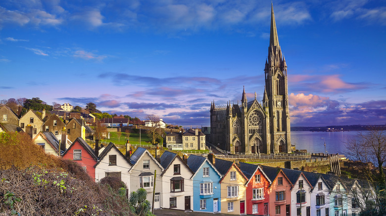 shot of colorful homes and cathedral in Cobh Ireland