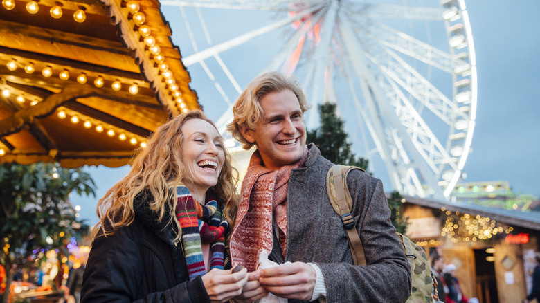 A happy couple enjoying a winter carnival