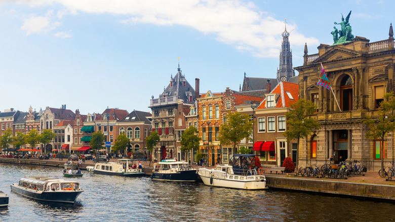 A Dutch city with a canal and boats on a sunny day